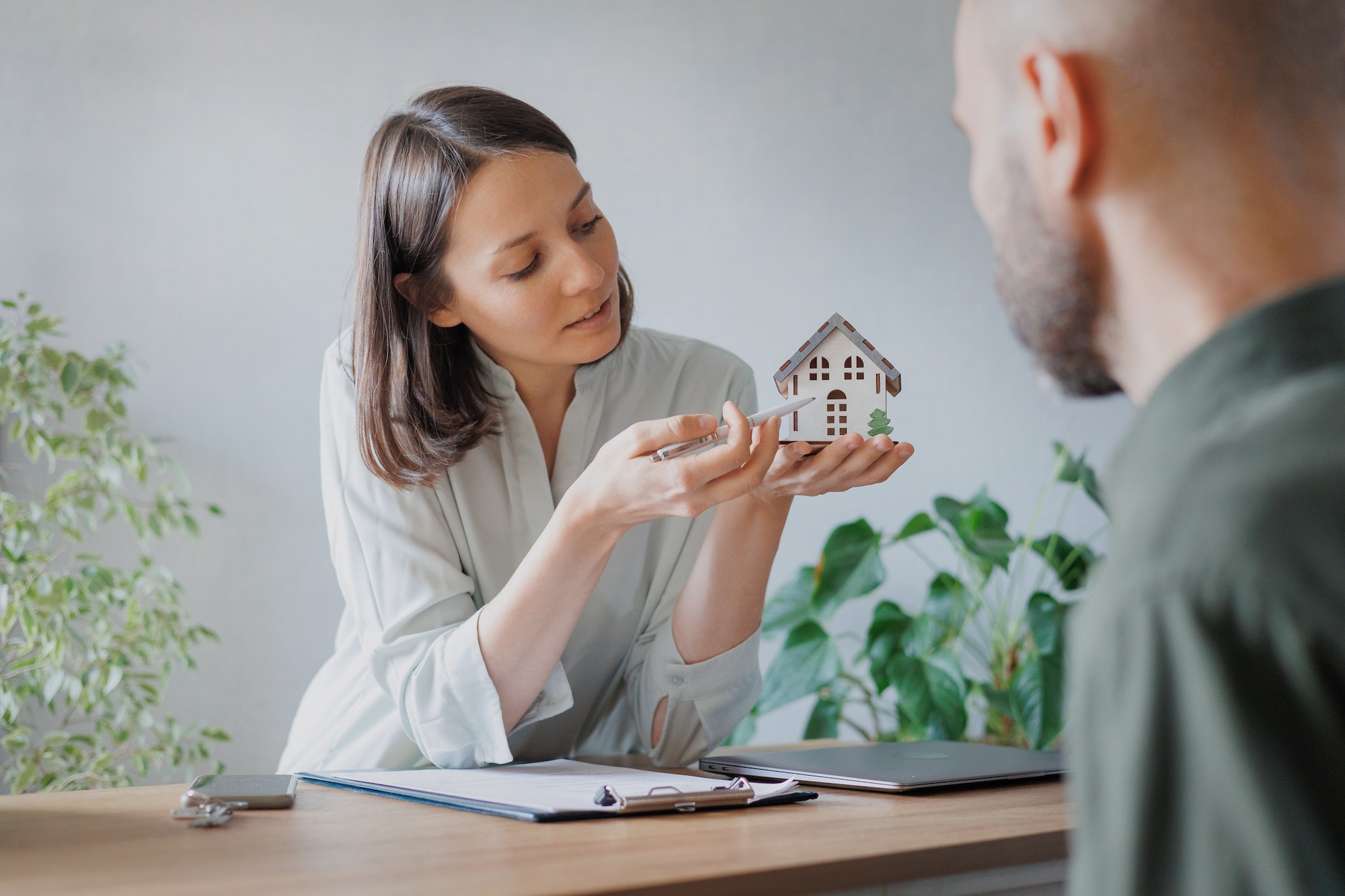 a woman and a man in a real estate office. a woman sells or buys real estate.