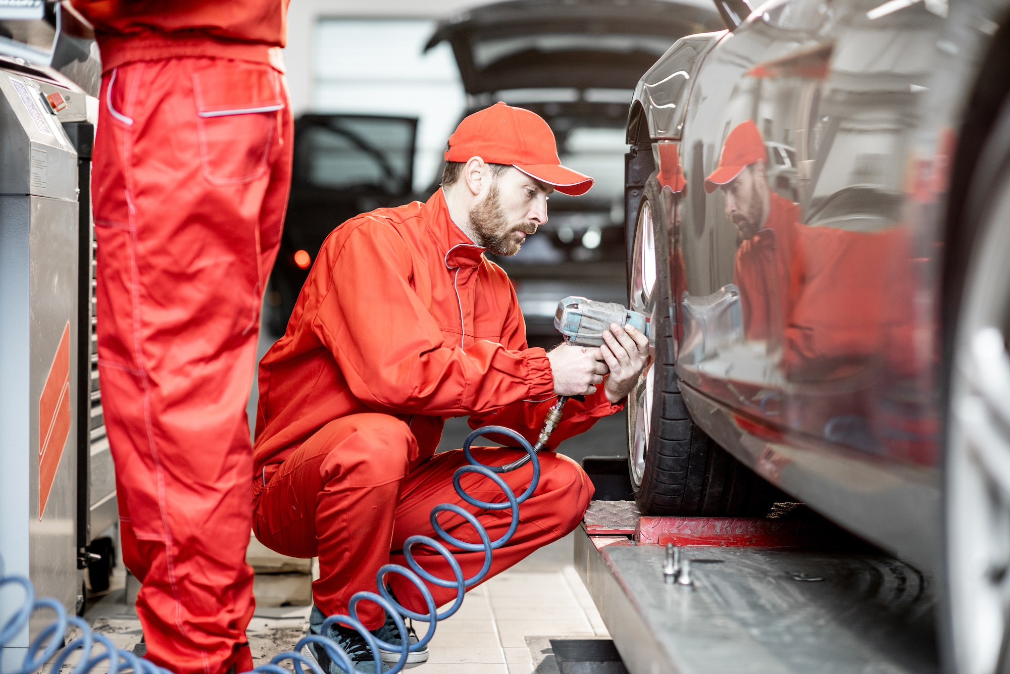 Workers changing wheels at the car service